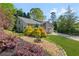A home featuring well-maintained landscaping with colorful flowerbeds and a verdant lawn at 890 Muirfield Rdg, Marietta, GA 30068