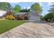 Charming single-Gathering home featuring a well-manicured lawn and inviting curb appeal with a wide driveway at 890 Muirfield Rdg, Marietta, GA 30068