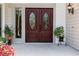 Elegant double front doors featuring leaded glass detailing, flanked by plants and decorative lighting at 890 Muirfield Rdg, Marietta, GA 30068