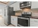 Kitchen with stainless steel appliances, granite countertops, and a sleek, modern design at 890 Muirfield Rdg, Marietta, GA 30068