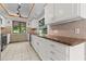 Well-lit kitchen with white cabinets, granite countertops, and stainless steel appliances at 890 Muirfield Rdg, Marietta, GA 30068