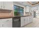 Kitchen area with white cabinets, granite countertops, and a large window providing natural light at 890 Muirfield Rdg, Marietta, GA 30068