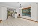 Bright eat-in kitchen featuring white cabinets, stone countertops and a large window overlooking the backyard at 890 Muirfield Rdg, Marietta, GA 30068