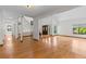 Bright open-concept living area with hardwood floors, staircase, and natural light from multiple windows at 890 Muirfield Rdg, Marietta, GA 30068