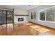 Cozy living room with a stone fireplace, hardwood floors, and sliding glass door to the backyard at 890 Muirfield Rdg, Marietta, GA 30068