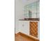 Stylish wet bar featuring granite countertop, glass shelves, and a wine rack at 890 Muirfield Rdg, Marietta, GA 30068