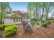 A large yard with a deck and gazebo, surrounded by lush landscaping and mature trees at 989 Vendue Dr, Lawrenceville, GA 30044