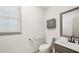 Bathroom with framed mirror and white toilet at 989 Vendue Dr, Lawrenceville, GA 30044