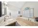 Primary bathroom featuring dual sinks, soaking tub, and neutral tile at 989 Vendue Dr, Lawrenceville, GA 30044