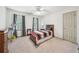 Bedroom with neutral walls and carpet, ceiling fan, and built-in shelves at 989 Vendue Dr, Lawrenceville, GA 30044