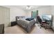 Bedroom with gray bed, black desk and chair, and natural light at 989 Vendue Dr, Lawrenceville, GA 30044