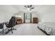 Bedroom with neutral walls and carpet, ceiling fan, dresser, and desk at 989 Vendue Dr, Lawrenceville, GA 30044