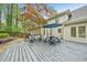 A spacious deck is furnished with a table, chairs, and umbrella, perfect for outdoor entertaining at 989 Vendue Dr, Lawrenceville, GA 30044