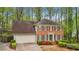 Charming brick home with manicured landscaping, two-car garage, and a welcoming front entrance at 989 Vendue Dr, Lawrenceville, GA 30044