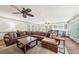 Spacious living room with a large sectional sofa, wet bar, hardwood floors, and plenty of natural light at 989 Vendue Dr, Lawrenceville, GA 30044
