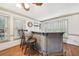 Wet bar with counter seating, decorative accents, and bright windows at 989 Vendue Dr, Lawrenceville, GA 30044
