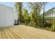 Spacious wooden deck with black metal railing surrounded by lush green trees at 2430 Dresden Parc Cir, Atlanta, GA 30345