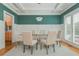 Open dining area with glass-top table, coffered ceiling, hardwood floors, and natural light at 2430 Dresden Parc Cir, Atlanta, GA 30345