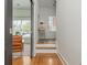 Bright entryway with hardwood floors, staircase, console table, leading to an adjacent room at 2430 Dresden Parc Cir, Atlanta, GA 30345