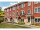 Charming brick townhome with manicured lawn and inviting front entrances under a blue sky at 2430 Dresden Parc Cir, Atlanta, GA 30345