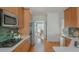 Well-lit kitchen features stainless steel appliances, wooden cabinets and hardwood floors at 2430 Dresden Parc Cir, Atlanta, GA 30345