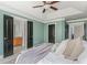 Bright bedroom featuring a tray ceiling, fan, and ensuite bath at 2430 Dresden Parc Cir, Atlanta, GA 30345