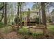 Expansive backyard with large deck, lush trees, and privacy fence at 2962 Moorings Pkwy, Snellville, GA 30039