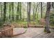 This large deck features wood benches and lush greenery creating a backyard sanctuary at 2962 Moorings Pkwy, Snellville, GA 30039
