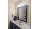 Well-lit bathroom featuring a modern vanity with marble countertop at 2962 Moorings Pkwy, Snellville, GA 30039
