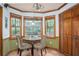 Cozy breakfast nook with natural light, bay windows, and comfortable seating for enjoying meals at 2962 Moorings Pkwy, Snellville, GA 30039