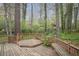 A spacious wooden deck with built-in benches, surrounded by mature trees and greenery at 2962 Moorings Pkwy, Snellville, GA 30039