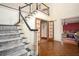 Welcoming foyer with hardwood floors, staircase, and view into adjacent living spaces at 2962 Moorings Pkwy, Snellville, GA 30039