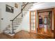 Elegant foyer with hardwood floors, staircase, and access to multiple rooms at 2962 Moorings Pkwy, Snellville, GA 30039