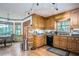 Traditional kitchen with wooden cabinetry, modern appliances, and an adjacent breakfast nook at 2962 Moorings Pkwy, Snellville, GA 30039