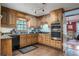 Bright kitchen featuring wooden cabinets, stainless steel appliances, and a view into an adjacent room at 2962 Moorings Pkwy, Snellville, GA 30039