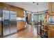 Spacious kitchen with stainless steel refrigerator, wooden cabinets, and a connected breakfast nook at 2962 Moorings Pkwy, Snellville, GA 30039
