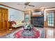 Bright living room features a decorative fireplace, hardwood floors, ceiling fan, and access to the backyard at 2962 Moorings Pkwy, Snellville, GA 30039