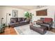 Cozy living room with comfortable leather furniture and hardwood floors at 2962 Moorings Pkwy, Snellville, GA 30039