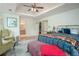 Spacious main bedroom with a tray ceiling, two sitting chairs, an ensuite bathroom, and a walk-in closet at 2962 Moorings Pkwy, Snellville, GA 30039