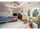 Spacious main bedroom with a tray ceiling, two sitting chairs, and hardwood floors at 2962 Moorings Pkwy, Snellville, GA 30039
