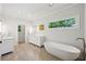 Bright bathroom featuring a soaking tub, double vanity, and modern fixtures at 4152 Club Ne Dr, Atlanta, GA 30319