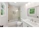 Bright bathroom with tub-shower with glass door, tiles, and a modern sink at 4152 Club Ne Dr, Atlanta, GA 30319