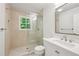 Well-lit bathroom with shower, neutral tile, and white vanity at 4152 Club Ne Dr, Atlanta, GA 30319