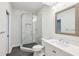 Bright bathroom featuring a glass shower with marble tile and a vanity with an decorative-framed mirror at 4152 Club Ne Dr, Atlanta, GA 30319