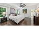 Bright bedroom has hardwood floors, a ceiling fan, and windows with views of the yard at 4152 Club Ne Dr, Atlanta, GA 30319