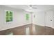 Bright bedroom with hardwood floors, crown molding, ceiling fan and two windows at 4152 Club Ne Dr, Atlanta, GA 30319