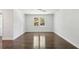 A spacious bedroom with two windows and shiny wood floors at 4152 Club Ne Dr, Atlanta, GA 30319