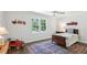 Cozy bedroom with natural light, decorative artwork, and wood flooring at 4152 Club Ne Dr, Atlanta, GA 30319