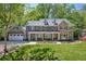 Beautiful two-story home with stone accents, a manicured lawn, and an attached two-car garage at 4152 Club Ne Dr, Atlanta, GA 30319