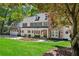 Charming two-story home with a manicured lawn, stone accents, and an attached two-car garage at 4152 Club Ne Dr, Atlanta, GA 30319